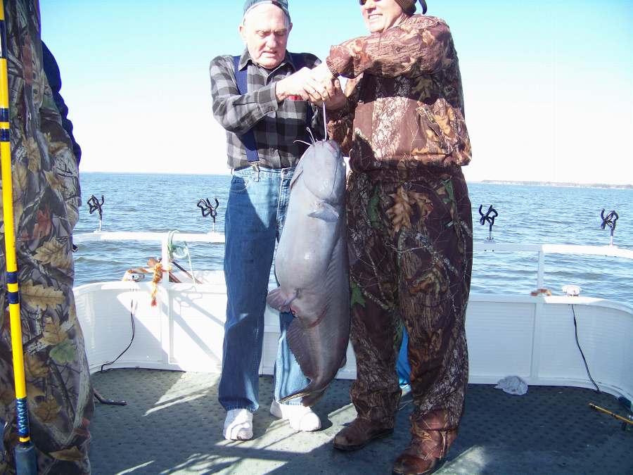 CHARLES HELPING HIS DAD HOLD HIS BIGGEST FISH OF THE DAY AT 36 POUNDS!  HARD TO BEAT THAT FOR 79 YEARS YOUNG!  1-31-09