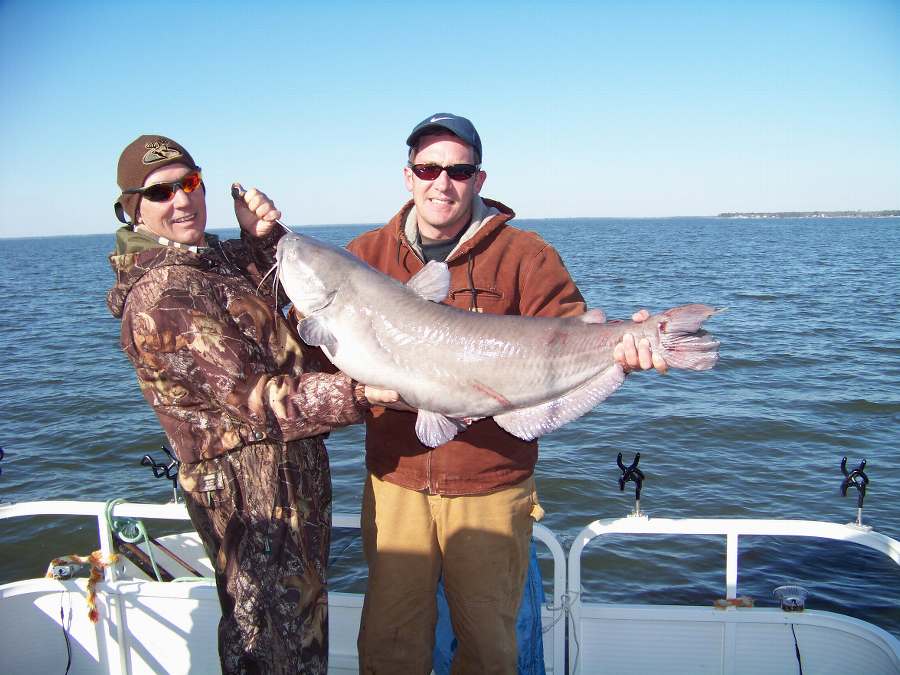 ME HELPING CHARLES HOLD A 26 POUNDER.  THIS WAS ONE OF 21 FISH FOR THE DAY! 1-31-09