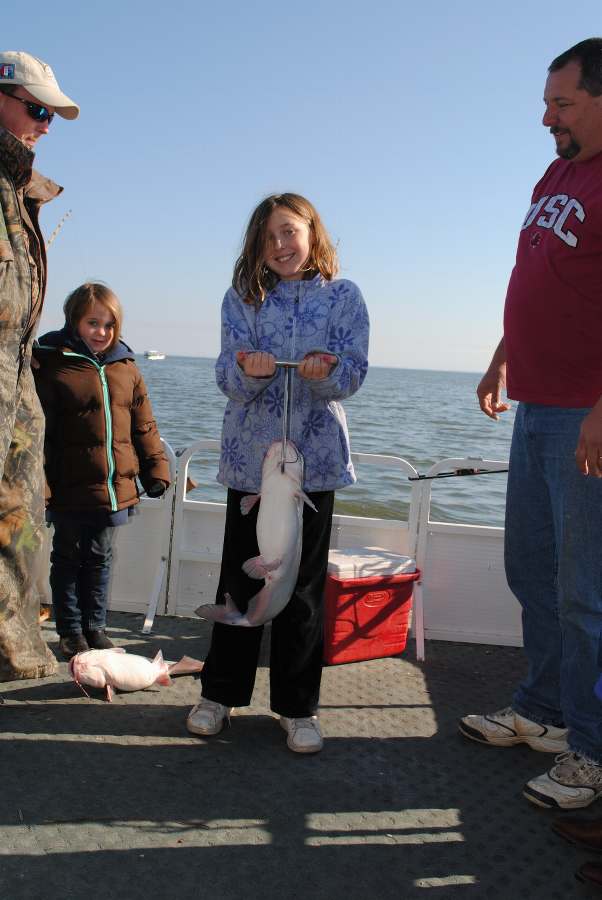 MAKENZIE WITH HER FIRST FISH OF THE DAY ON 12-31-10